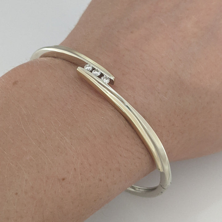10K TWO-TONE .15 CARAT TOTAL WEIGHT SI2 K DIAMOND ROUND (3) BYPASS ESTATE BANGLE 14.5 GRAMS