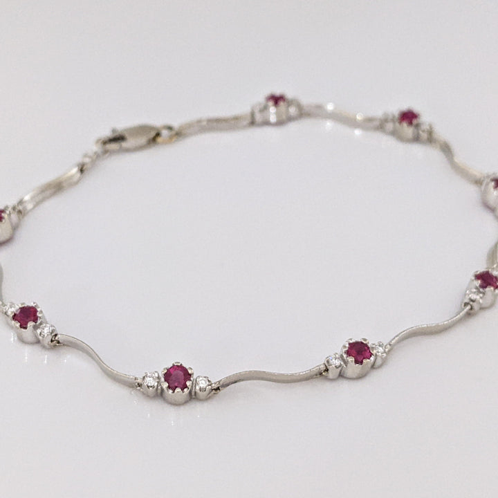 14K WHITE RUBY ROUND (8) 3MM WITH .16 DIAMOND TOTAL WEIGHT (16) ESTATE WAVY BRACELET 4.3 GRAMS
