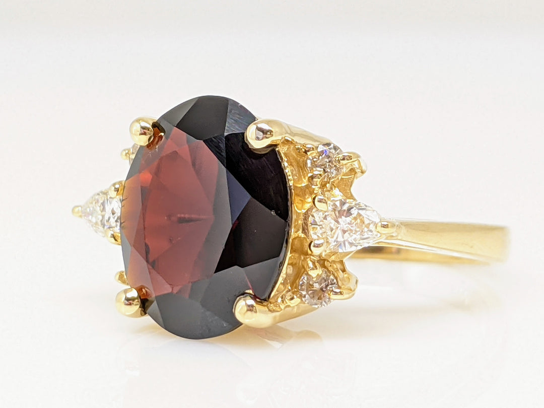 14K GARNET OVAL 9X12 WITH (2) PEAR AND (4) ROUND DIAMONDS ESTATE RING 4.9 GRAMS