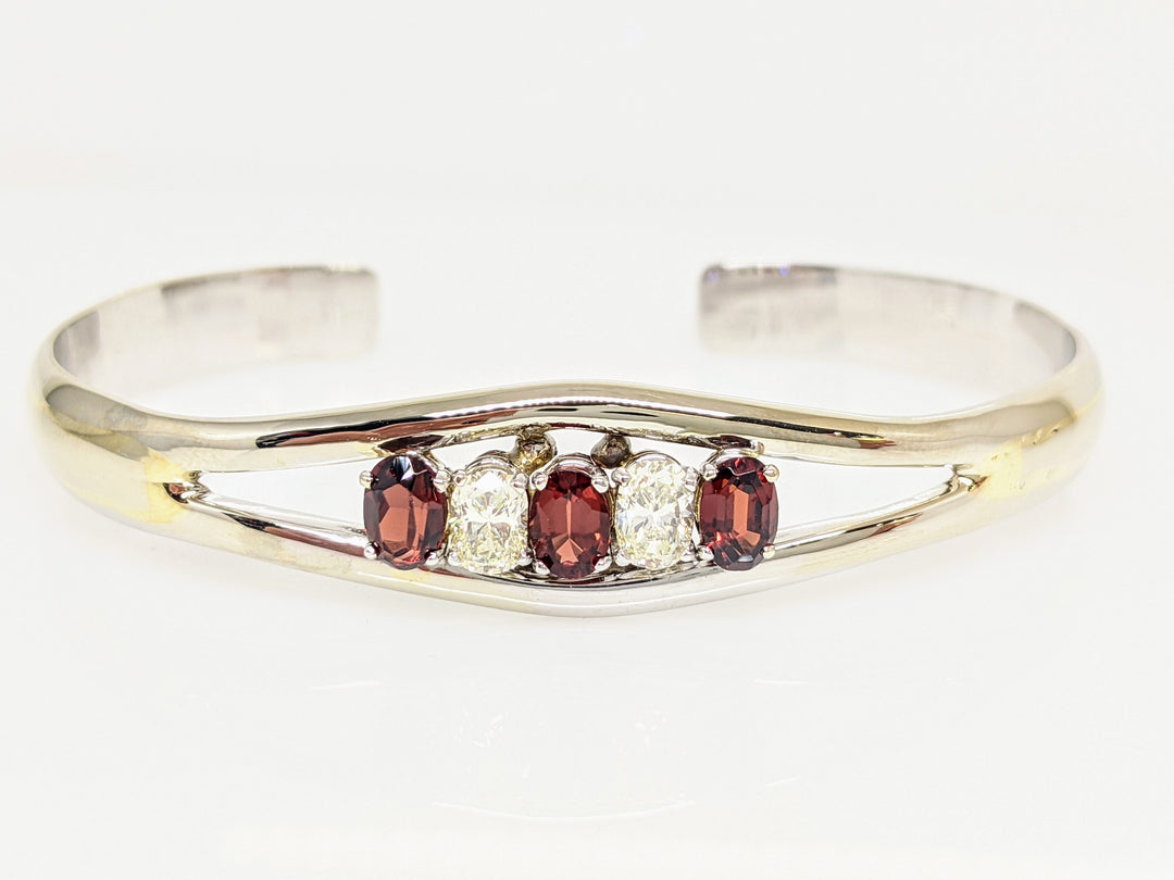 10KW GARNET OVAL 4X6 (3) WITH (2) DIAMOND .90 CARAT TOTAL WEIGHT OVAL ESTATE BANGLE 23.0 GRAMS
