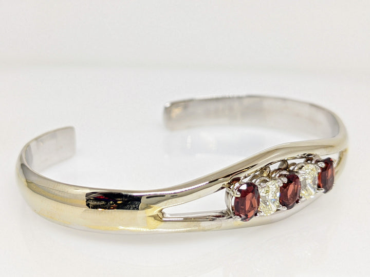 10KW GARNET OVAL 4X6 (3) WITH (2) DIAMOND .90 CARAT TOTAL WEIGHT OVAL ESTATE BANGLE 23.0 GRAMS