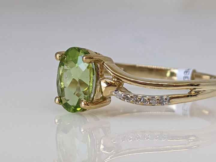 10K PERIDOT OVAL 5X7 WITH 12 MELEE ESTATE RING 2.2 GRAMS